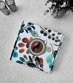 Notebook with a floral and coffee design on a textured surface