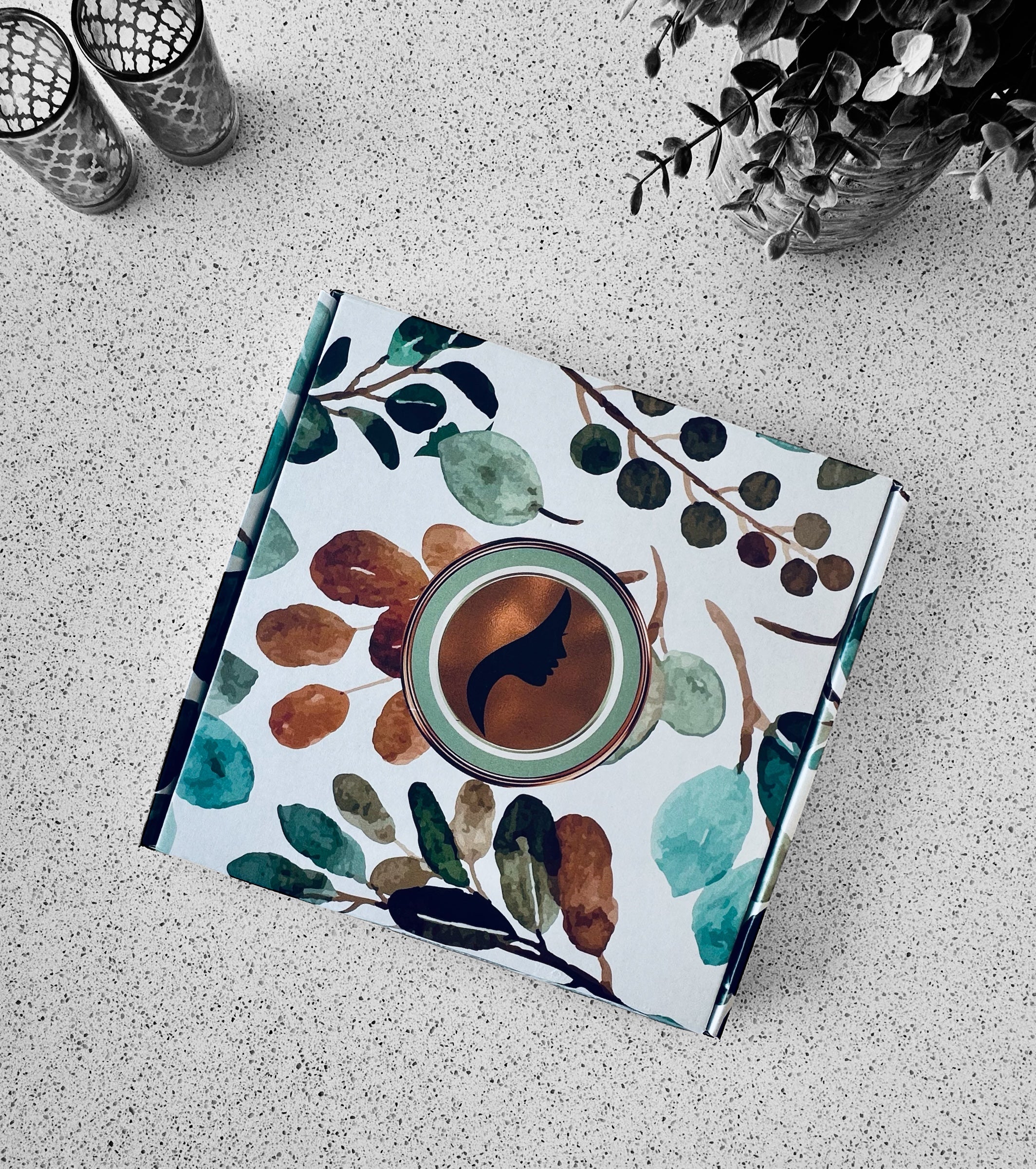 Notebook with a floral and coffee design on a textured surface
